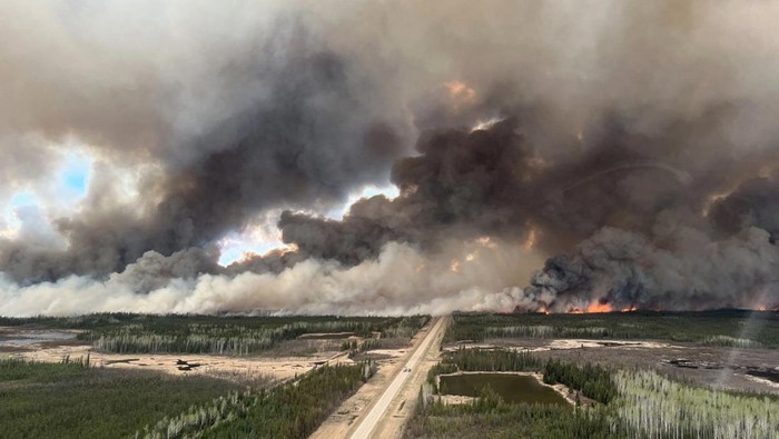 A picture taken through a window shows smoke rising from wildfire MWF017 on the south side of the Athabasca River valley near Fort McMurray, Alberta, Canada May 10, 2024. Alberta Wildfire/Handout via REUTERS THIS IMAGE HAS BEEN SUPPLIED BY A THIRD PARTY. NO RESALES. NO ARCHIVES