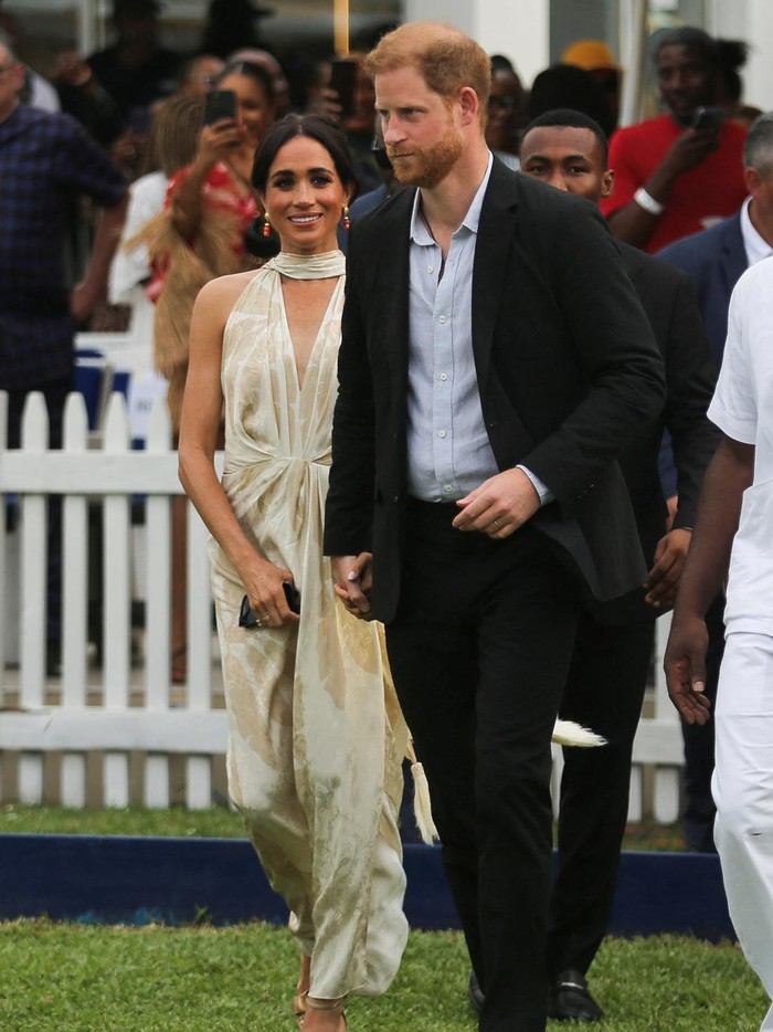 Meghan Markle Britains Prince Harry, Duke of Sussex and his wife Meghan, Duchess of Sussex, walk out after meeting the students at the Lightway Academy in Abuja, Nigeria, May 10, 2024. REUTERS/Akintunde Akinleye TPX IMAGES OF THE DAY