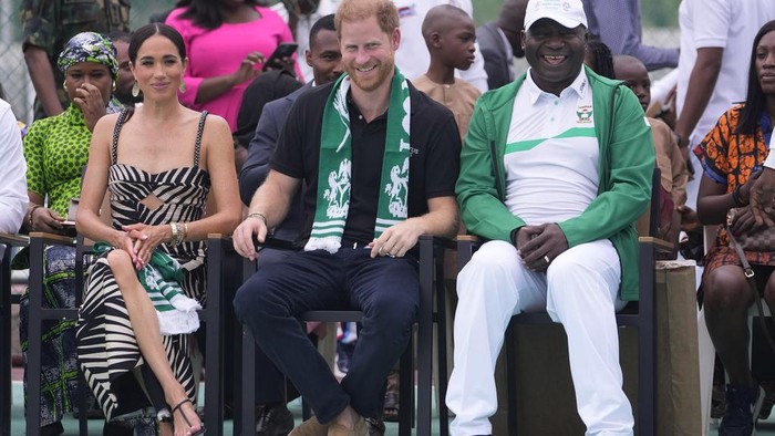 Prince Harry, left, and Meghan, right, holding hands upon arrival at the government house in Lagos Nigeria, Sunday, May 12, 2024. Prince Harry and his wife Meghan are in Nigeria to champion the Invictus Games, which Prince Harry founded to aid the rehabilitation of wounded and sick servicemembers and veterans. (AP Photo/Sunday Alamba)