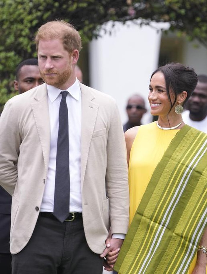 Meghan Markle Prince Harry, left, and Meghan, right, holding hands upon arrival at the government house in Lagos Nigeria, Sunday, May 12, 2024. Prince Harry and his wife Meghan are in Nigeria to champion the Invictus Games, which Prince Harry founded to aid the rehabilitation of wounded and sick servicemembers and veterans. (AP Photo/Sunday Alamba)