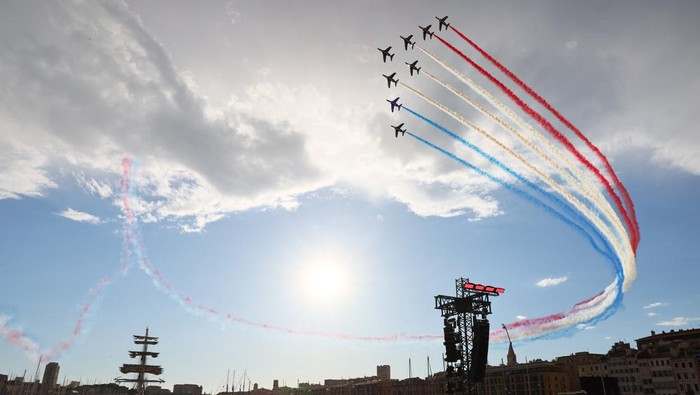 Paris Olympics 2024 - Arrival of the Olympic Flame in Marseille - Marseille, France - May 8, 2024  General view as planes release colored smoke as the 