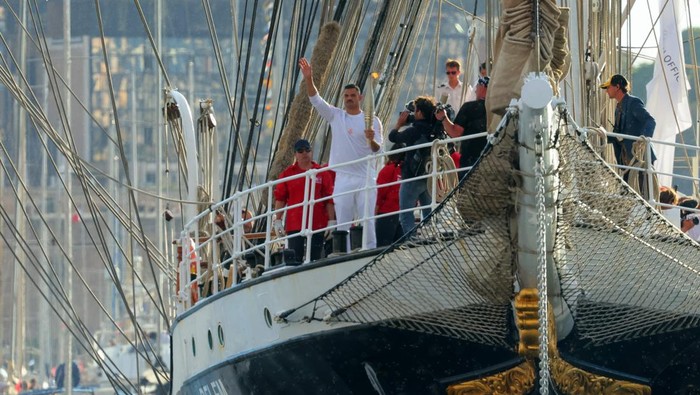 Paris Olympics 2024 - Arrival of the Olympic Flame in Marseille - Marseille, France - May 8, 2024  French swimmer Florent Manaudou holds the Olympic Flame on the 