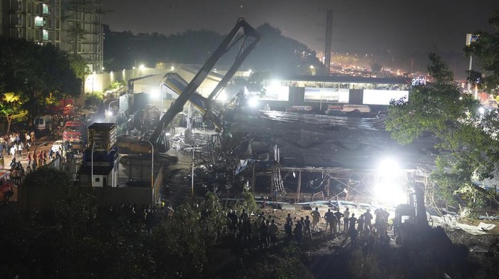 Rescuers look for victims under a billboard that collapsed following heavy rain and thundershowers in Mumbai, India, Monday, May 13, 2024. Scores of people were thought to be trapped after the collapse in the suburb of Ghatkopar, Mumbai police said on social media platform X. (AP Photo/Rafiq Maqbool)