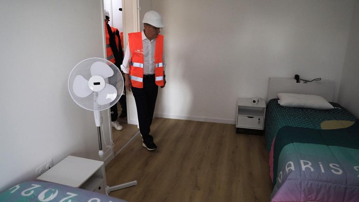 International Olympic Committee (IOC) president Thomas Bach enters a room as he visits the Athletes' village in Saint-Ouen-sur-Seine, outside Paris, Tuesday, July 25, 2023. (Pascal Rossignol/Pool via AP)