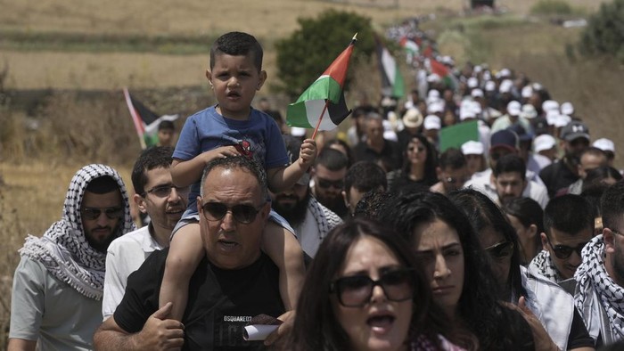 People take part in a march in support of the Palestinian people ahead the Nakba day at the Al Kasayir village, in Haifa, Tuesday, May 14, 2024. Palestinians on Wednesday, May 15, 2024, will mark the 76th year of their mass expulsion from what is now Israel. They refer to it as the Nakba, Arabic for catastrophe. (AP Photo/Mahmoud illean)