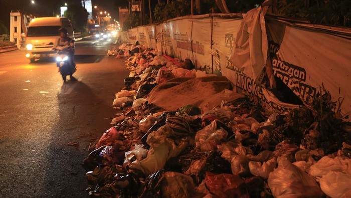 Pengendara melintas di dekat tumpukan sampah di Banguntapan, Bantul, DI Yogyakarta, Selasa (14/5/2024). Penumpukan sampah terjadi di sejumlah lokasi di Kota Yogyakarta, Bantul dan Sleman disebabkan belum optimalnya fasilitas pengolahan sampah tiap kota/kabupaten dampak penutupan permanen TPST Piyungan. ANTARA FOTO/Hendra Nurdiyansyah/rwa.