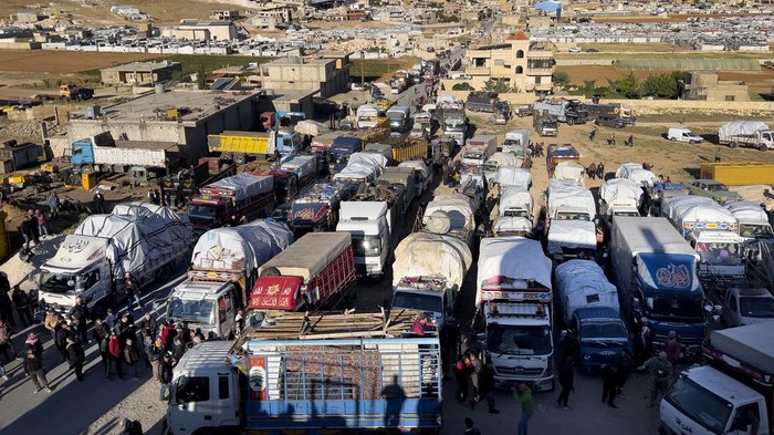 Syrian refugees gather near trucks with their belongings, as they prepare to go back home to Syria as a part of a voluntary return, in the eastern Lebanese border town of Arsal, Tuesday, May 14, 2024. Hundreds of Syrians refugees left a remote northeastern Lebanese town back to Syria in a convoy, amid a surge in anti-refugee sentiment in the small, crisis-hit country. Lebanese officials for years has urged the international community to resettle the refugees in other countries or help them return to Syria. (AP Photo/Hussein Malla)