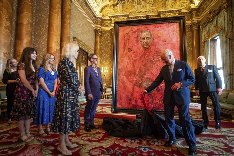 Artist Jonathan Yeo and Britain's King Charles III at the unveiling of Yeo's portrait of the King, in the blue drawing room at Buckingham Palace, in London, Tuesday May 14, 2024. The portrait was commissioned in 2020 to celebrate the then Prince of Wales's 50 years as a member of The Drapers' Company in 2022. The artwork depicts the King wearing the uniform of the Welsh Guards, of which he was made Regimental Colonel in 1975. The canvas size - approximately 8.5 by 6.5 feet when framed - was carefully considered to fit within the architecture of Drapers' Hall and the context of the paintings it will eventually hang alongside. (Aaron Chown/Pool Photo via AP)