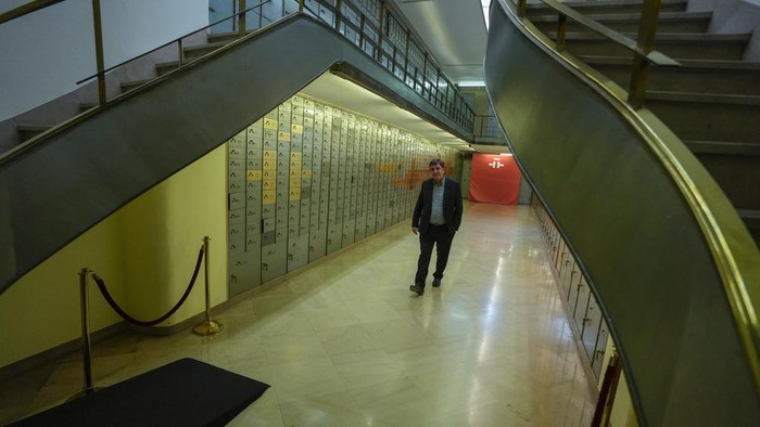 The Director of the Cervantes Institute, Luis Garcia Montero poses inside the old bank vault before an interview with The Associated Press inside the Cervantes Institute in Madrid, Spain, Wednesday, April 24, 2024. (AP Photo/Paul White)