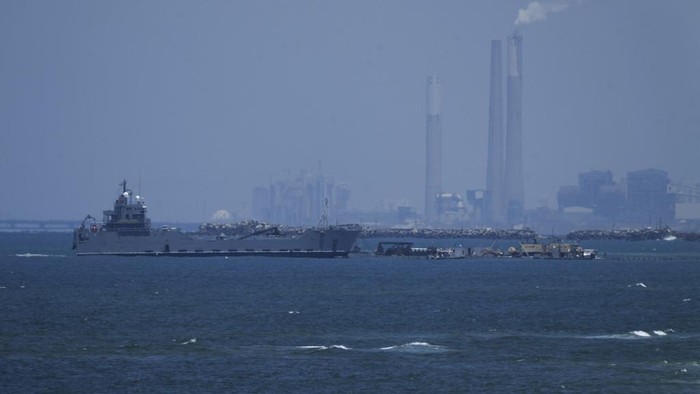 A ship is seen off the coast of Gaza near a U.S.-built floating pier that will be used to facilitate aid deliveries, as seen from the central Gaza Strip, Thursday, May 16, 2024. (AP Photo/Abdel Kareem Hana)