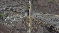Jalan pedesaan yang menjadi jalur alternatif ke kabupaten lain pascabanjir bandang lahar dingin Gunung Marapi itu dipadati kendaraan yang harus melintas secara bergantian karena ukuran jembatan yang kecil.