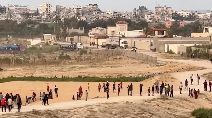 Truk Bantuan Mulai Tiba di Gaza Melalui Dermaga Apung yang Dibangun AS Trucks carrying aid delivered into Gaza via a U.S.-built pier move, as seen from central Gaza Strip, in this still image taken from a video, May 17, 2024. REUTERS/Reuters TV TPX IMAGES OF THE DAY