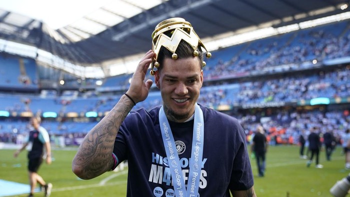 Manchester Citys goalkeeper Ederson celebrates with the Premier League trophy after the English Premier League soccer match between Manchester City and West Ham United at the Etihad Stadium in Manchester, England, Sunday, May 19, 2024. Manchester City clinched the English Premier League on Sunday after beating West Ham in their last match of the season. (AP Photo/Dave Thompson)