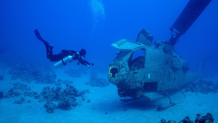 A diver swims next to a submerged military vehicle at the Underwater Military Museum in Aqaba, Jordan, May 7, 2024. REUTERS/Stelios Misinas