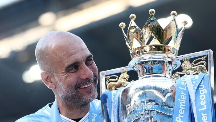 MANCHESTER, ENGLAND - MAY 19: Pep Guardiola, Manager of Manchester City, holds the Premier League title trophy following the teams victory in the Premier League match between Manchester City and West Ham United at Etihad Stadium on May 19, 2024 in Manchester, England. (Photo by Naomi Baker/Getty Images)