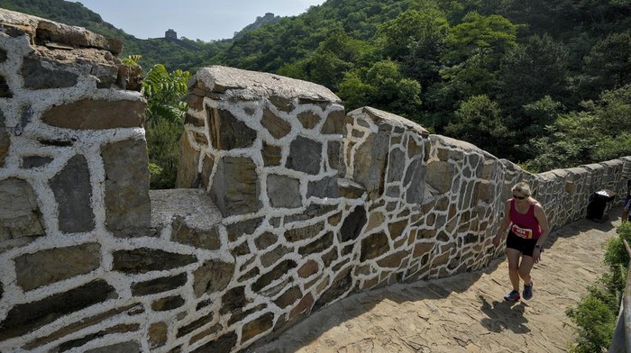 Runners make their way on a narrow and steep stretch of the Huangyaguan Great Wall route during the Great Wall Marathon in Jizhou, on the outskirts of Beijing, Saturday, May 18, 2024. Professional and running enthusiasts raced along a section of the iconic Great Wall of China. (AP Photo/Andy Wong)