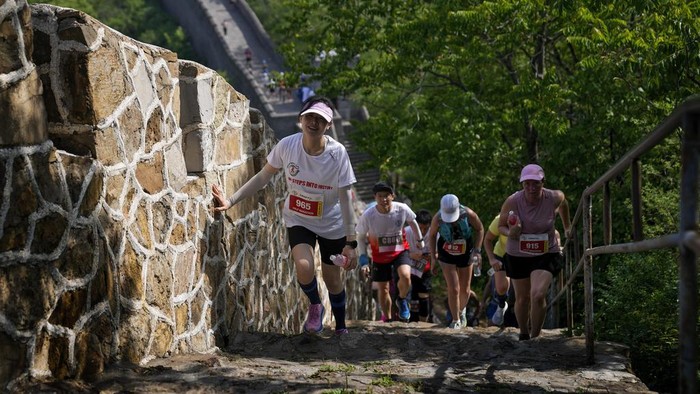 Runners make their way on a narrow and steep stretch of the Huangyaguan Great Wall route during the Great Wall Marathon in Jizhou, on the outskirts of Beijing, Saturday, May 18, 2024. Professional and running enthusiasts raced along a section of the iconic Great Wall of China. (AP Photo/Andy Wong)