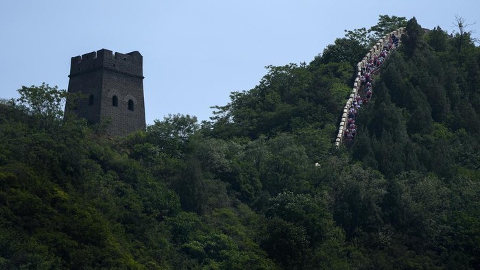 Runners make their way on a narrow and steep stretch of the Huangyaguan Great Wall route during the Great Wall Marathon in Jizhou, on the outskirts of Beijing, Saturday, May 18, 2024. Professional and running enthusiasts raced along a section of the iconic Great Wall of China. (AP Photo/Andy Wong)