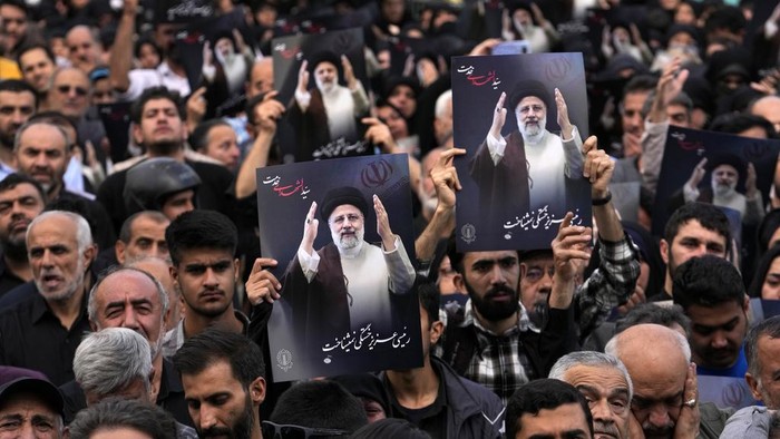 A cleric weeps during a mourning ceremony for Iranian President Ebrahim Raisi at Vali-e-Asr square in downtown Tehran, Iran, Monday, May 20, 2024. President Raisi and the country's foreign minister were found dead Monday hours after their helicopter crashed in fog, leaving the Islamic Republic without two key leaders as extraordinary tensions grip the wider Middle East. (AP Photo/Vahid Salemi)