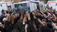 Ribuan orang berusaha memegang peti mati sang presiden. (Iranian Presidency Office via AP)  