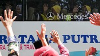 Para jemaah haji membalas lambaian tangan keluarga dari dalam bus. Sebanyak 221 dari 2.432 jemaah haji asal Sidoarjo akan diberangkatan ke Tanah Suci melalui Bandara Internasional Juanda.   