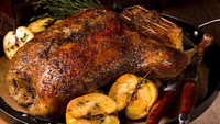 Polandia memiliki hidangan tradisional yang unik berbahan bebek. Namanya Kaczka z jabłkami, untuk membuatnya dibutuhkan bebek utuh yang diisi dengan buah apel dan dipanggang hingga renyah. Foto: Taste Atlas