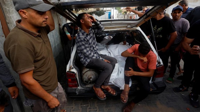 Mourners react next to the bodies of Palestinians killed in an Israeli strike on an area designated for displaced people, during their funeral in Rafah, in the southern Gaza Strip, May 27, 2024. REUTERS/Mohammed Salem