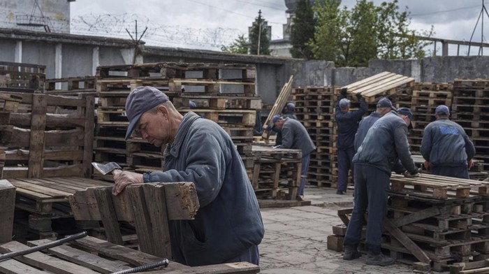 Captured Russian soldiers walk to shelters during an air raid alarm at the prisoner of war detention center in Ukraine's Lviv region, Thursday, April 25, 2024. AP visited the center as part of a small group of journalists on the condition that its exact location be withheld.  (AP Photo/Evgeniy Maloletka)