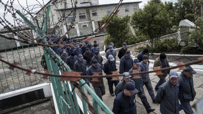 Captured Russian soldiers walk to shelters during an air raid alarm at the prisoner of war detention center in Ukraine's Lviv region, Thursday, April 25, 2024. AP visited the center as part of a small group of journalists on the condition that its exact location be withheld.  (AP Photo/Evgeniy Maloletka)