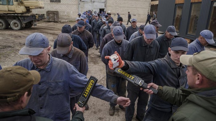 Captured Russian soldiers walk to shelters during an air raid alarm at the prisoner of war detention center in Ukraine's Lviv region, Thursday, April 25, 2024. AP visited the center as part of a small group of journalists on the condition that its exact location be withheld. (AP Photo/Evgeniy Maloletka)