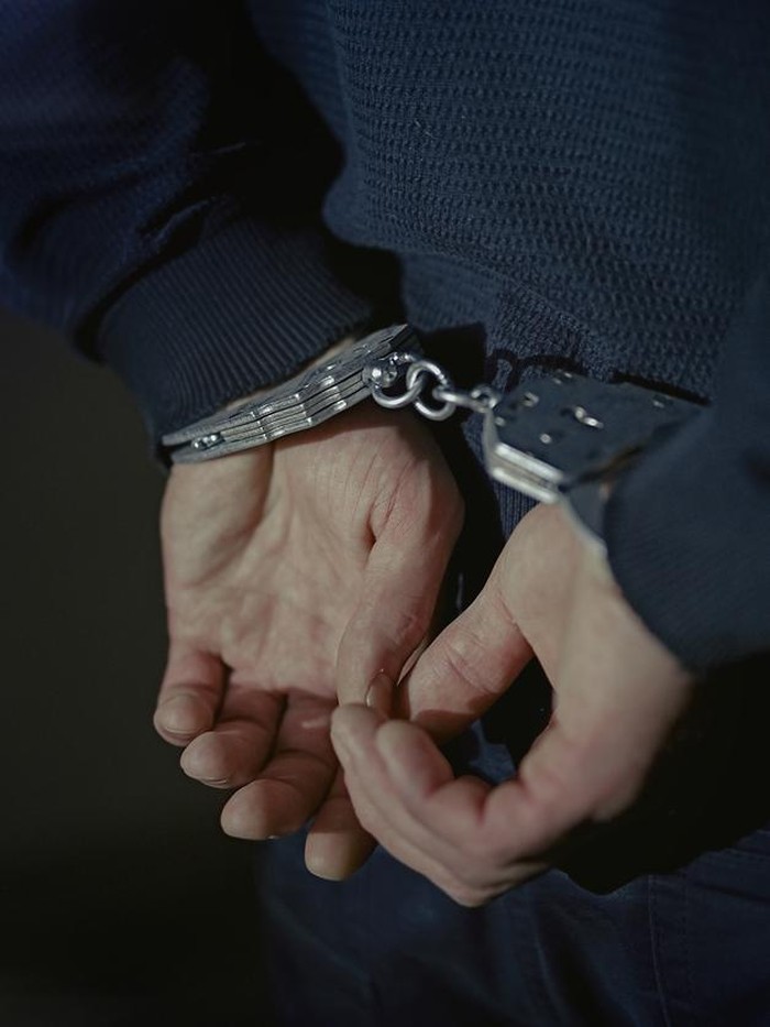 Arrested man handcuffed hands at the back