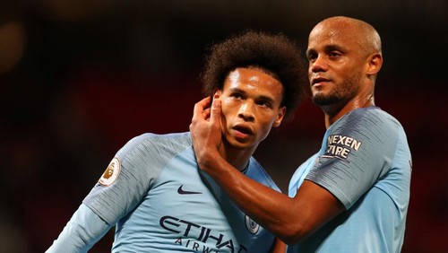 MANCHESTER, ENGLAND - APRIL 24:  Vincent Kompany of Manchester City celebrates with teammate Leroy Sane after the Premier League match between Manchester United and Manchester City at Old Trafford on April 24, 2019 in Manchester, United Kingdom. (Photo by Catherine Ivill/Getty Images)