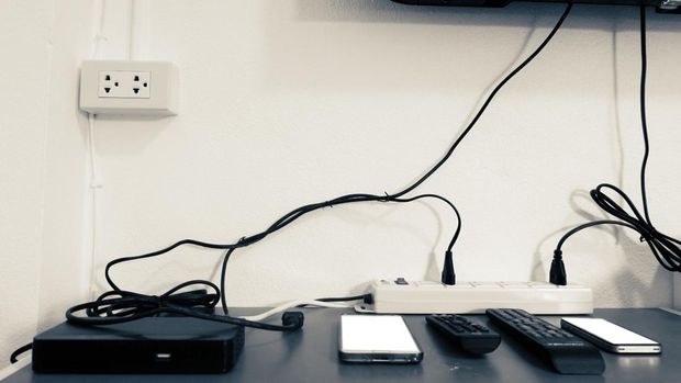 Electronic devices on the table under the TV such as smartphone,tv box,remote all in room