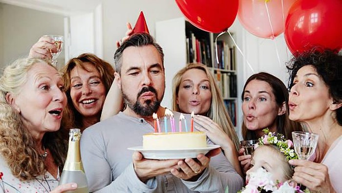 family celebrating birthday of an adult man