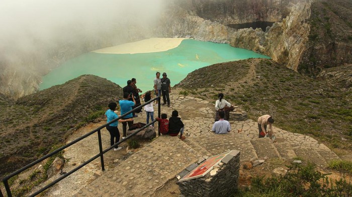 Kenaikan status Gunung Kelimutu Pengunjung berfoto di Danau Kelimutu, Gunung Kelimutu, Kabupaten Ende, Nusa Tenggara Timur, Minggu (2/6/2024). Gunung api jenis strato yang memiliki tiga danau kawah, yakni Kawah I (Tiwu Ata Polo), Kawah II (Tiwu Koofai Nuwamuri), dan Kawah III (Tiwu Ata Bupu) tersebut mengalami kenaikan status dari level I atau normal ke level II atau waspada pada tanggal 24 Mei 2024 karena adanya perubahan yang signifikan warna air danau kawah I maupun kenampakan dan sebaran belerang di permukaan air danau kawah II yang semakin intensif. ANTARA FOTO/Mega Tokan/sgd/foc.