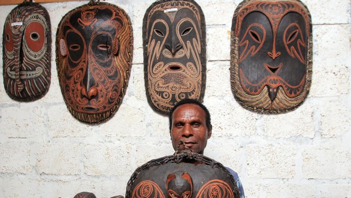 Seorang perajin menunjukkan patung etnik yang dibuat di Jayapura Utara, Kota Jayapura, Papua, Sabtu (1/6/2024). Kerajinan kayu motif etnis Papua tersebut di jual Rp300 ribu - Rp1 juta per buah.ANTARA FOTO/Gusti Tanati/wpa.