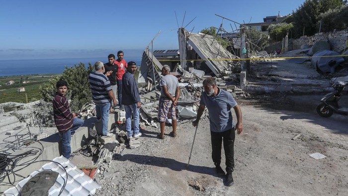 A Lebanese man gestures as he inspects a destroyed house that was hit on Friday night by an Israeli airstrike, killing one woman and wounding several other people, in the southern village of Adloun, Lebanon, Saturday, June 1, 2024. The militant Hezbollah group shot down Saturday an Israeli Hermes 900 Kochav drone over south Lebanon, after hours of Israeli drones strikes that killed at least one person and wounded others. (AP Photo/Mohammad Zaatari)