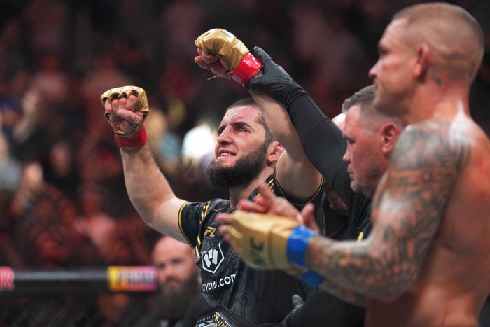 Jun 1, 2024; Newark, New Jersey, USA; Islam Makhachev (red gloves) celebrates defeating Dustin Poirier (blue gloves) during UFC 302 at Prudential Center. Mandatory Credit: Joe Camporeale-USA TODAY Sports