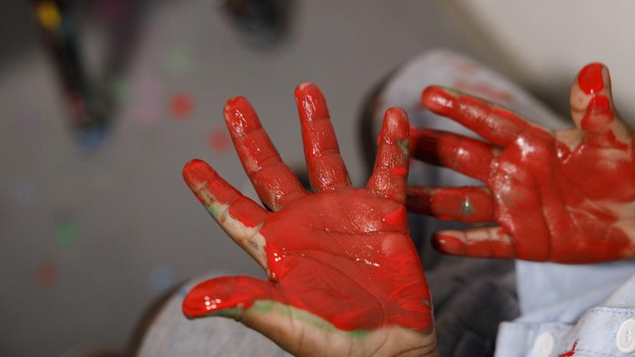 Ace-Liam Nana Sam Ankrah, who will turn two in July, paints at his mother's art gallery in Accra, Ghana, Monday, May 27, 2024. Ankrah has set the record as the world's youngest male artist. His mother, Chantelle Kukua Eghan, says it all started by accident when her son, who at the time was 6 months old, discovered her paints. (AP Photo/Misper Apawu)