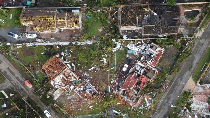 People sift through the remains of their homes damaged by a tornado in Tongaat, South Africa, June 4, 2024. REUTERS/Rogan Ward