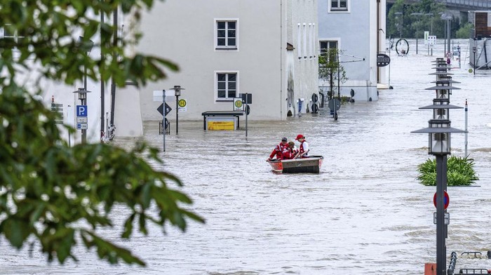 A lifeboat navigates through the flood waters of the Danube in the old town of Passau, Germany, Tuesday June 4, 2024. After heavy rainfall, many places in Bavaria continue to be flooded. (Armin Weigel/dpa via AP)
