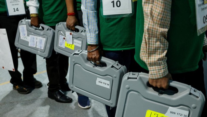 People hold sealed electronic voting machines (EVM) inside a vote counting centre for India's general elections in Mumbai, India, June 4, 2024. REUTERS/Francis Mascarenhas