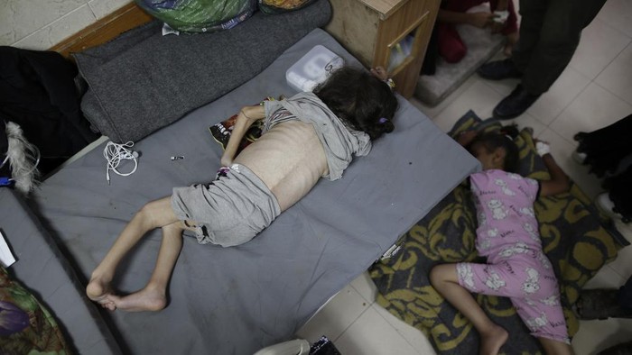Amira Al-Jojo, left, stands beside her 10-month-old son, Yousef Al-Jojo, who suffers from malnutrition at Al-Aqsa Martyrs Hospital, where he is undergoing treatment, in Deir al-Balah in the central Gaza Strip on Saturday, June 1, 2024. At right is Nuha Al-Khaldi and her child. (AP Photo/ Jehad Alshrafi)