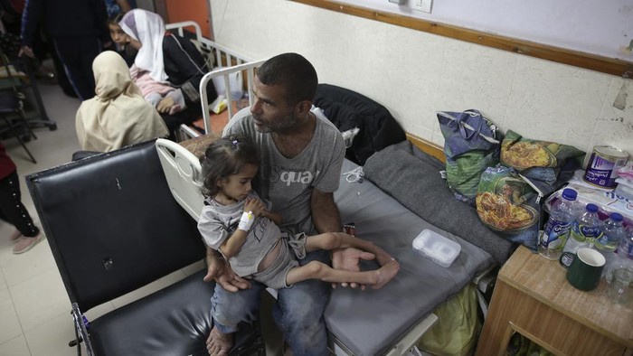 Amira Al-Jojo, left, stands beside her 10-month-old son, Yousef Al-Jojo, who suffers from malnutrition at Al-Aqsa Martyrs Hospital, where he is undergoing treatment, in Deir al-Balah in the central Gaza Strip on Saturday, June 1, 2024. At right is Nuha Al-Khaldi and her child. (AP Photo/ Jehad Alshrafi)