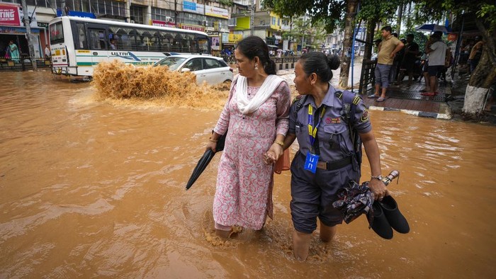 A family on a scooter wades through a flooded street after heavy monsoon rains in Guwahati, India, Wednesday, June 5, 2024. (AP Photo/Anupam Nath)