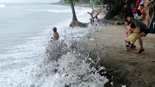 Sejumlah wisatawan mancanegara menyaksikan gelombang tinggi di Pantai Kuta, Badung, Bali, Jumat (7/6/2024). Balai Besar Meteorologi Klimatologi dan Geofisika Wilayah III Denpasar mengeluarkan peringatan dini per Sabtu (8/6) untuk mewaspadai potensi hujan yang dapat disertai kilat/petir dan tinggi gelombang laut mencapai dua meter atau lebih di Selat Bali bagian selatan, Selat Badung, Selat Lombok bagian Selatan, Perairan Selatan Bali, dan Samudera Hindia Selatan Bali. ANTARA FOTO/Nyoman Hendra Wibowo/rwa.