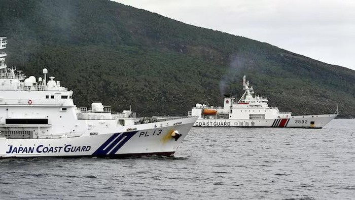 A China Coast Guard vessel No.2502 sails near a Japan Coast Guard vessel Motobu off Uotsuri Island, one of a group of disputed islands called Senkaku Islands in Japan, also known in China as Diaoyu Islands, in the East China Sea April 27, 2024, in this photo released by Kyodo. Mandatory credit Kyodo/via REUTERS/File Photo Purchase Licensing Rights, opens new tab