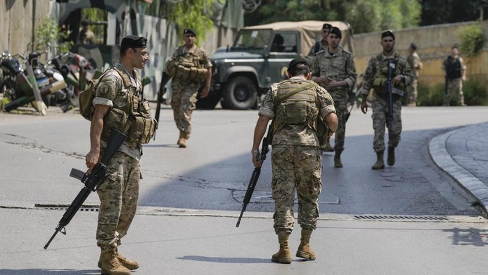 Lebanese security stand guard on a road that leads to the U.S. Embassy in Aukar, a northern suburb of Beirut, Lebanon, Wednesday, June 5, 2024. A gunman was captured by Lebanese soldiers after attempting to attack the U.S. Embassy near Beirut on Wednesday, the military said. (AP Photo/Bilal Hussein)