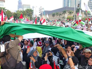 Massa Aksi Bentangkan Bendera Palestina Raksasa di Monas
