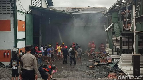 Petugas memadamkan api saat kebakaran gudang LPG dan paralon di Jalan Cargo Utara, Denpasar, Bali, Minggu (9/6/2024). (Foto: Ahmad Firizqi Irwan/detikBali)